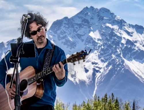 Photo courtesy of Steve Norwood Steve Norwood performs in front of Pioneer Peak at the Great Alaska Music Fest in Palmer, May 2018.