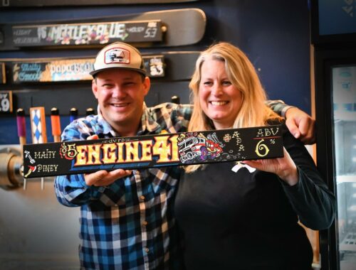 Girdwood Brewing Company Beer Ambassador Josh Hegna and GVF&R Chief Michelle Weston hold up the sign for Engine 41, an American pale ale brewed to celebrate the department’s 60th anniversary. A dollar from every Engine 41 sold will be donated to GVF&R.